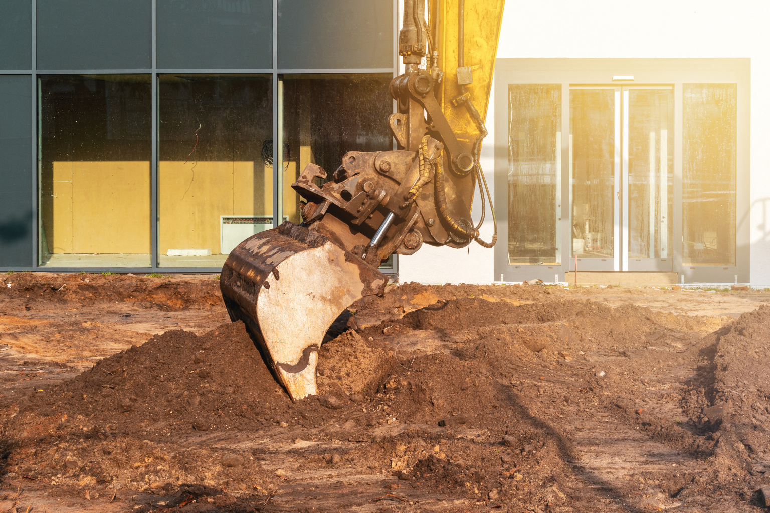 Excavator bucket scooping dirt