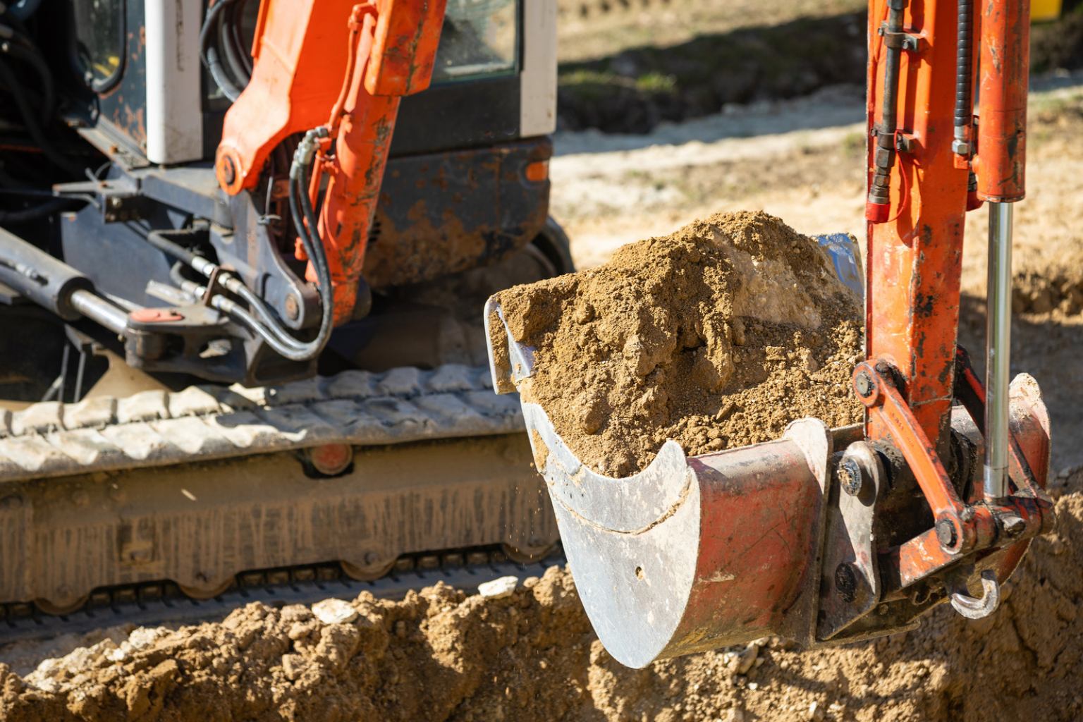 Excavator scooping dirt