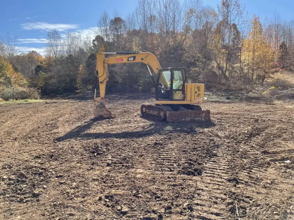 Excavator moved piles and leveled the site