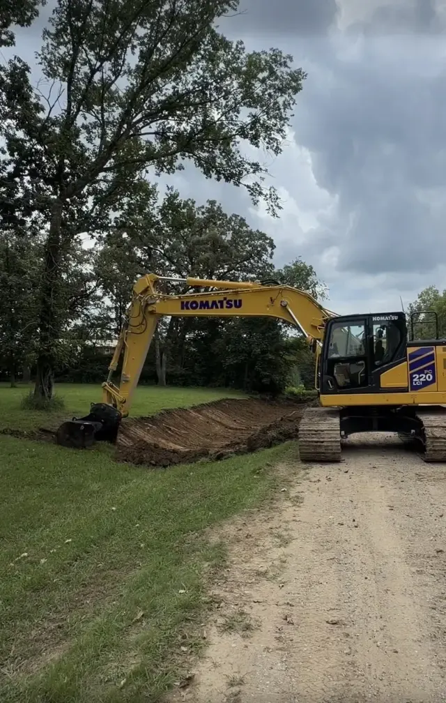 Excavator cleaning a ditch for better drainage