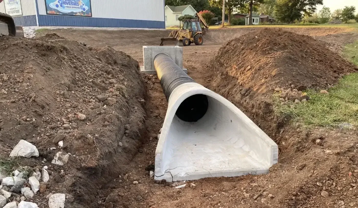 Drainage earthwork alongside a building